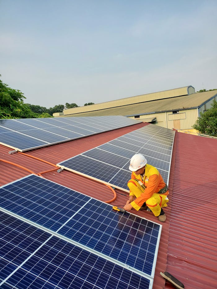Crafting Captivating Headlines: Your awesome post title goes here Technician working on solar panel installation on a rooftop under clear sky.